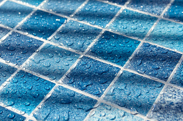 Blue Tiles in Swimming Pool Blue Tiles in Swimming Pool With Water Drops in Sunlight blue condensation stock pictures, royalty-free photos & images