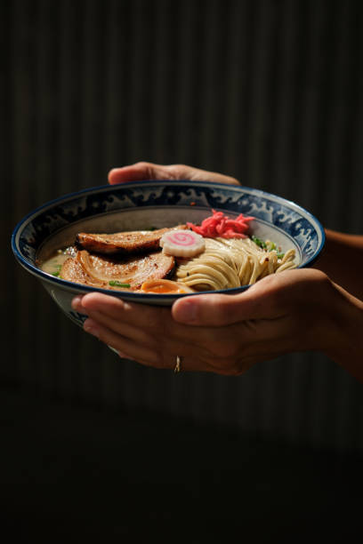 istock Crop female with portion of ramen under sunlight 1582270957