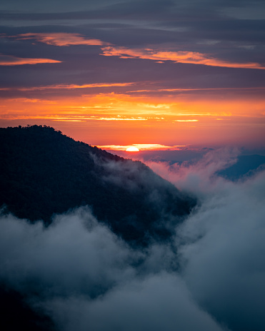 sunrise behind mountain peak covered by the sea of cloud in northern of thailand (Nan province, Thailand) เด่นช้างนอน