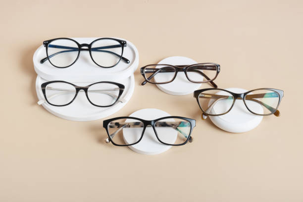 istock Podiums with eyeglasses on colored background. Optical store, vision test, stylish glasses concept top view, flat lay 1582275297