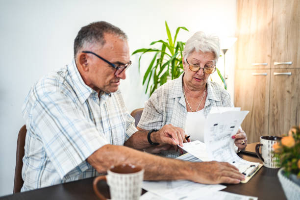 istock Married senior couple doing home finances together at home 1582294196