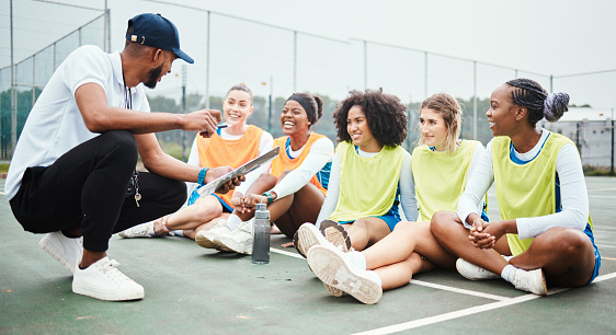 Netball strategy, happy sports team and coach planning game plan, teamwork collaboration or explain competition idea. Coaching athlete, teaching or talking group of people listen to fitness challenge