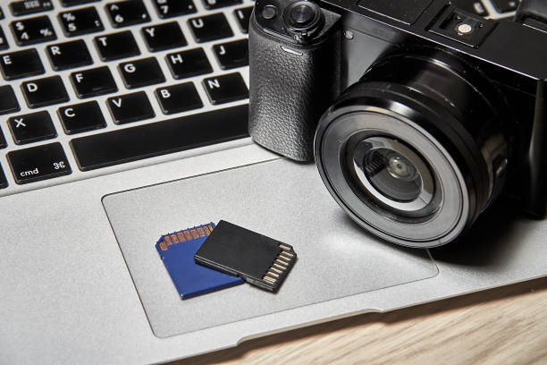 istock The memory cards and the camera are lying on the laptop 1582304952