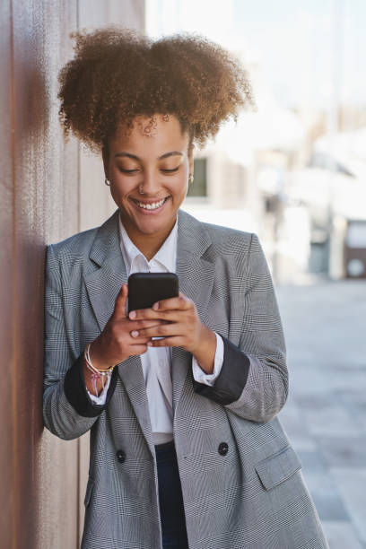 istock Carefree black lady browsing smartphone on street 1582316221