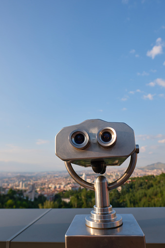 Binoculars facing the town of Ankara, with cityscape behind out of focus.
