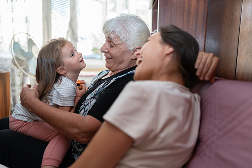 Multigenerational family get together at home. Sharing family moments and caring for each other.