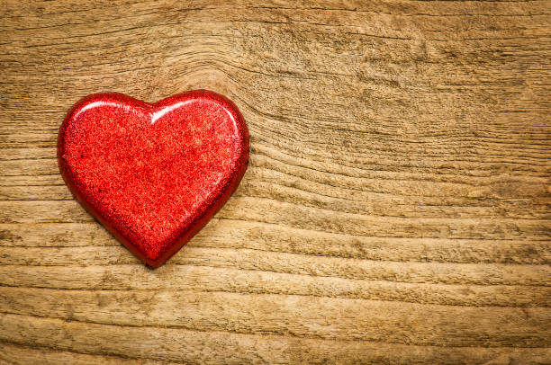 istock Red heart chocolate on old wooden background 1582354670