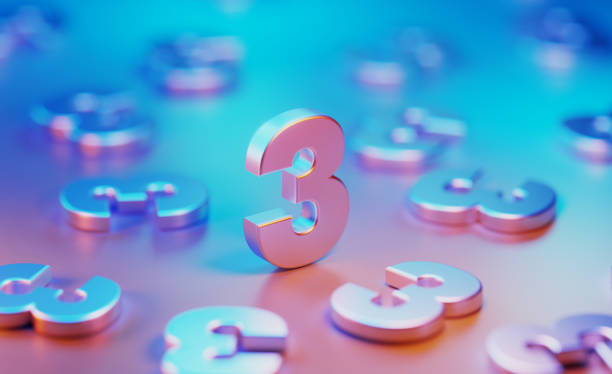 istock Metallic Number Threes Illuminated By Blue And Pink Lights On Blue And Pink Background 1582356894