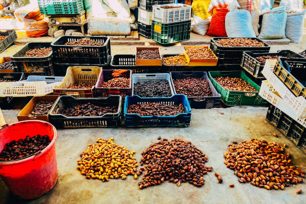 Harvested dates in plastic boxes on food market.