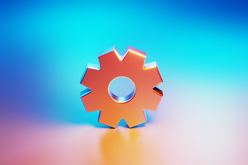 Metallic cog object illuminated by blue and pink lights on blue and pink background. Horizontal composition with copy space.