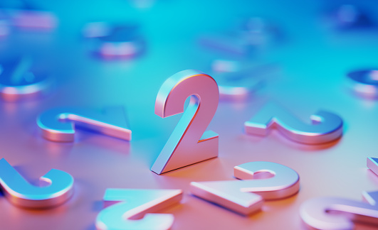 Metallic number twos illuminated by blue and pink lights on blue and pink background. Horizontal composition with copy space.