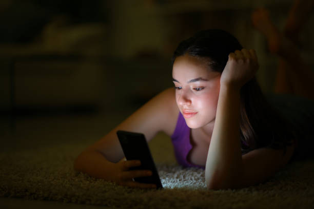 istock Woman in the night using phone on the floor 1582369644