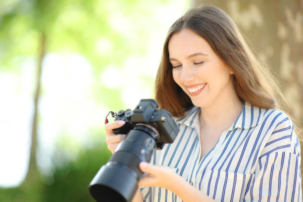 istock Satisfied photographer checking photos on camera 1582370276