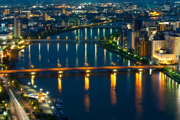 The Shinano River flows through Niigata City and empties into the Sea of Japan. Niigata Prefecture is known for having the highest rice production in Japan and is also famous for its clean water. There are several bridges over the Shinano River, but the Bandai Bridge is the most famous one, captivating tourists with its beautiful reflection on the river from evening till night.