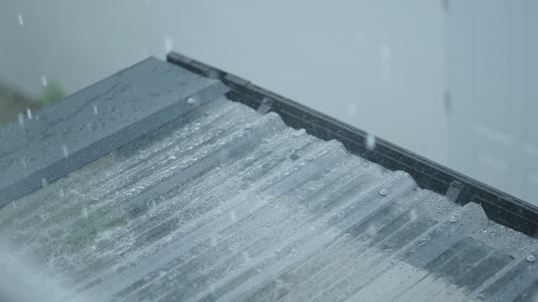 Slow motion heavy rain on transparent roof