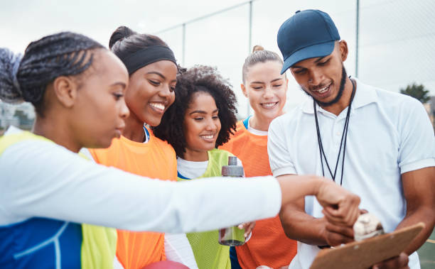 istock Strategy, planning and coach with netball team for sports game plan, teamwork and competition discussion. Man coaching diversity athlete women talking about fitness goals training and motivation 1582384793