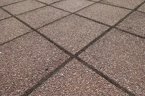 Background - pavement made of pink tiles of resin bound gravel