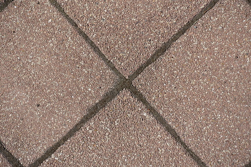 Macro of pavement made of pink tiles of resin bound gravel