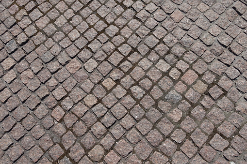 Backdrop - pavement made of rectangular pink granite stone setts