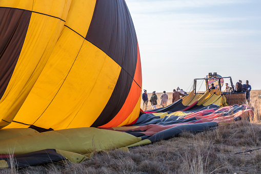 Air Ventures balloon safaris in Johannesburg at cradlemoon nature reserve with the balloon just landed and the the group of guests climbing off  the basket. July 29, 2023.