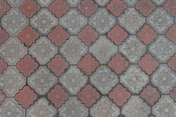 Background - old and dirty red and grey curvy segmental concrete pavement