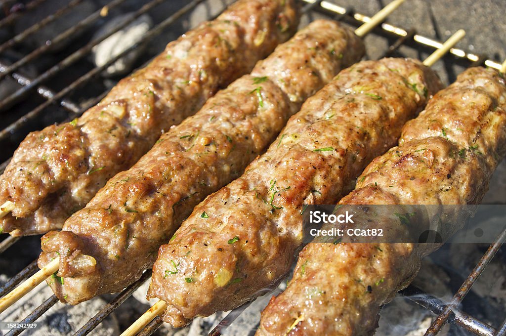 Kebab during the preparation Kebab during the preparation on the grill Barbecue - Meal Stock Photo