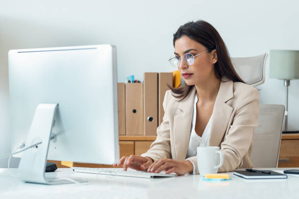 istock Elegant smart business woman working with computer in the office 1582432780