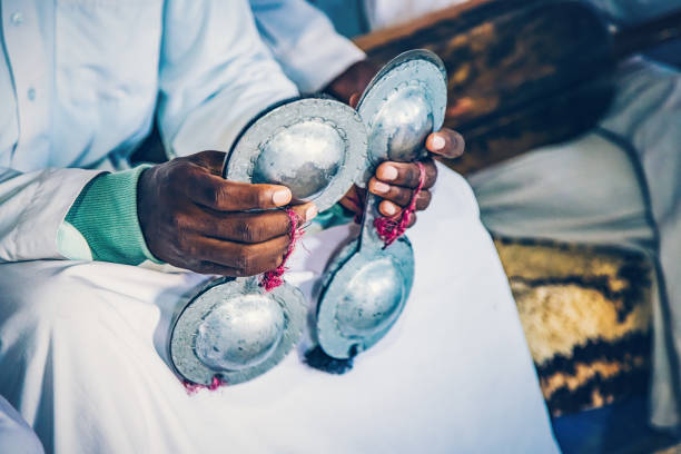 Hands of Moroccan band musician playing on  krakeb (Qraqeb), Merzouga.