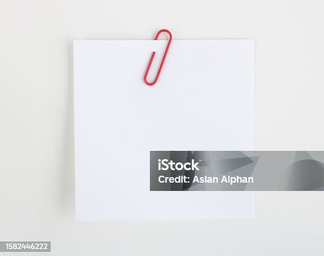 istock Paper clip holding a blank 1582446222