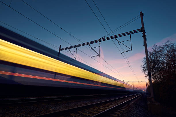 istock Long exposure of train on railroad track at sunrise 1582446232