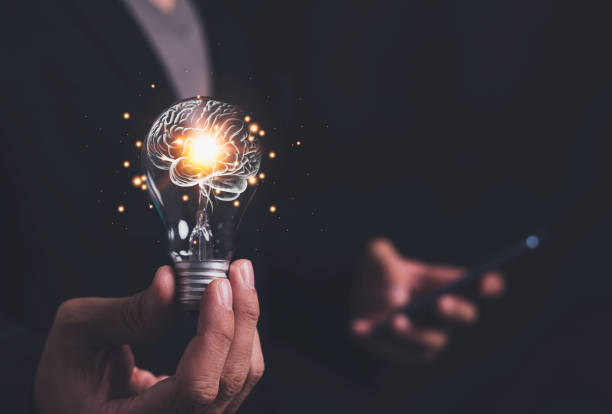 istock Businessman holding light bulb and brain inside, creativity and inspiration, idea and imagination. Scientific Innovation with Technological Innovation Network Analysis Solution Development 1582481198