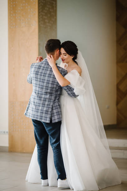 istock First wedding dance. Happy stylish bride and groom dancing and having fun at a wedding reception in a restaurant. Newlyweds are dancing in the hall. 1582489703