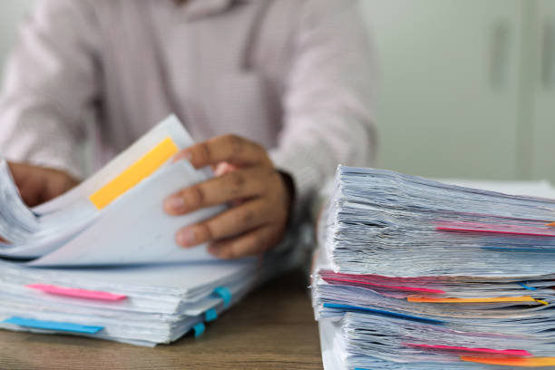 istock business administration and data documents on office desk, Stack of business overload paper. 1582497770