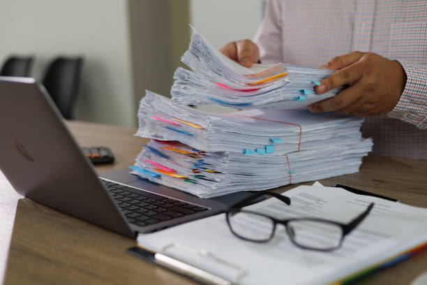 istock business administration and data documents on office desk, Stack of business overload paper. 1582497782