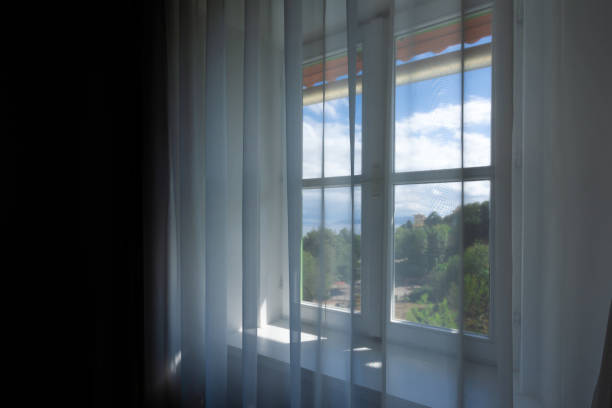 istock Window shutters and curtains at seaside apartment, selective focus 1582508288