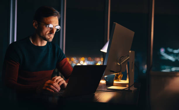 istock Virtual meeting at night: Businessman connecting with his colleagues while working from home 1582513268