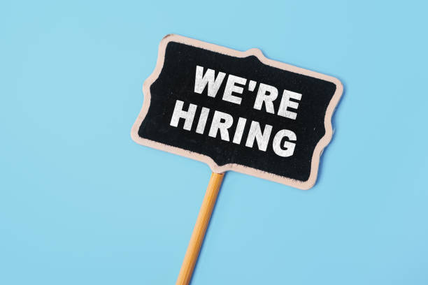 istock We're Hiring - text on a small chalkboard on a blue background. Top view. Human resource concept, strategy, plan, planning 1582515425