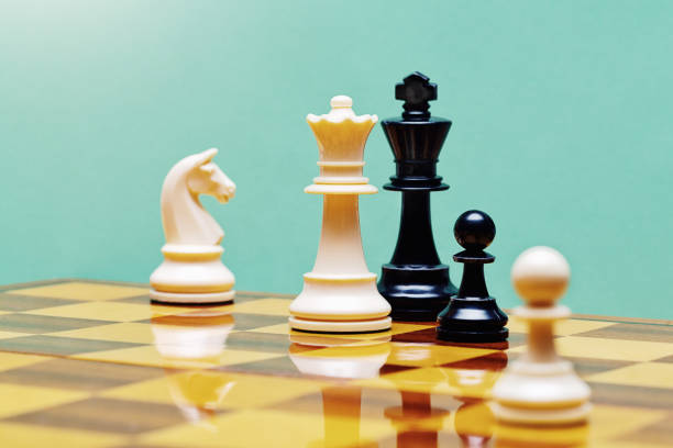 istock Checkmate! White queen defeats black king in a game of chess 1582519712