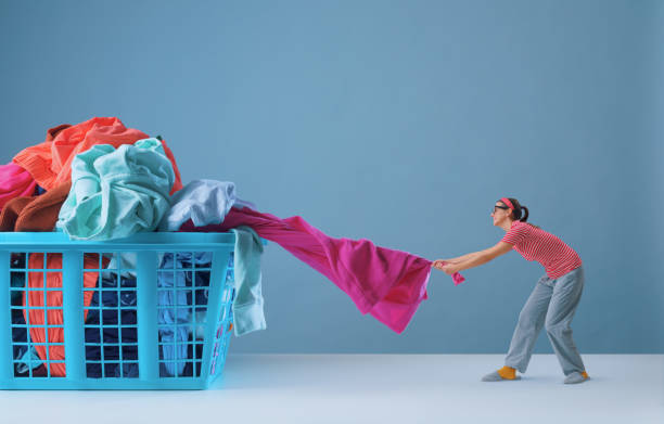 istock Tiny woman and a full laundry basket 1582520804