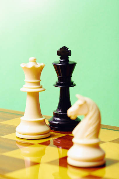 istock Checkmate! White queen defeats black king in a game of chess 1582520812