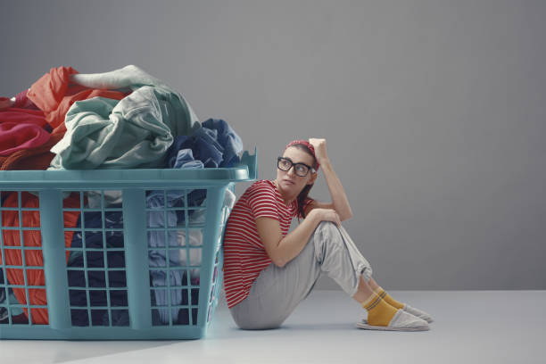 istock Tiny woman and a full laundry basket 1582525305