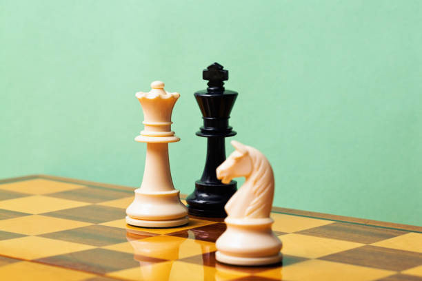 istock Checkmate! White queen defeats black king in a game of chess 1582526894