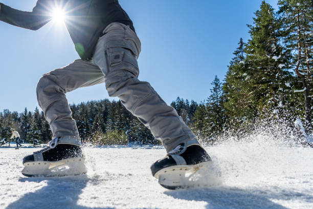 Man ice skating on frozen lake