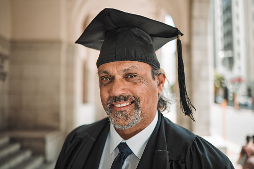 Senior lawyer, graduation and portrait of man in street, city or outdoor with smile. Elderly attorney, face or happy person, advocate or professional with success in education at university in Brazil