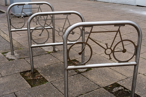 Gateshead, United Kingdom – June 28, 2023: Street bicycle rack with cycle design. Urban sustainability in transport concept.