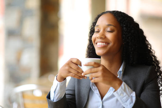 istock Happy black executive breathing in a coffee shop 1582560038