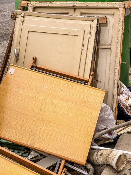 istock Wooden doors lying on garbage container in the street 1582571930
