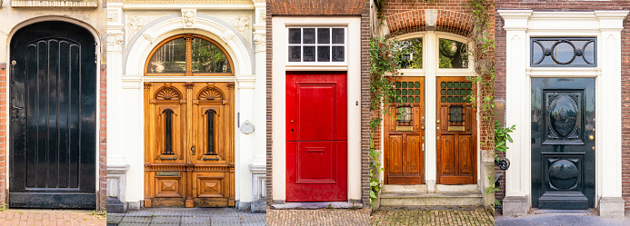 A series of five old-fashioned entrance doors to historic apartment buildings surrounding the canals in Amsterdam's historic centre.