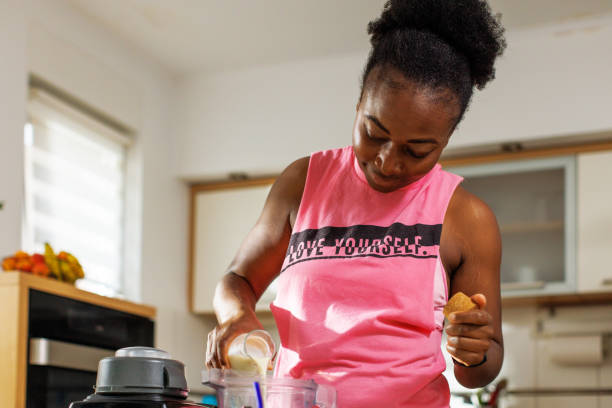 istock A Black Woman Making Protein Shake After Exercise 1582579266