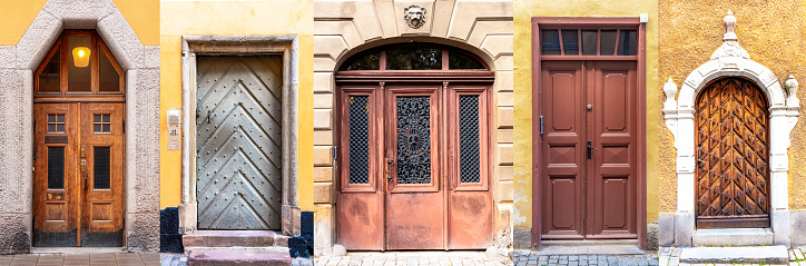 A group of five traditional apartment entrance doors in Gamla Stan, the historic old town of Stockholm, Sweden.